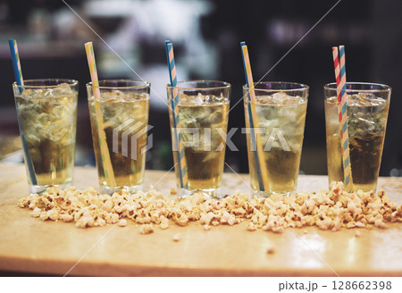 beautiful and delicious alcoholic cocktails prepared at the bar by the bartender. 128662398