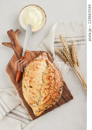 Tasty multigrain french bread with butter 128663584
