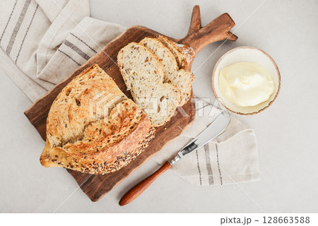 Tasty multigrain french bread with butter Tasty multigrain french bread with butter 128663588