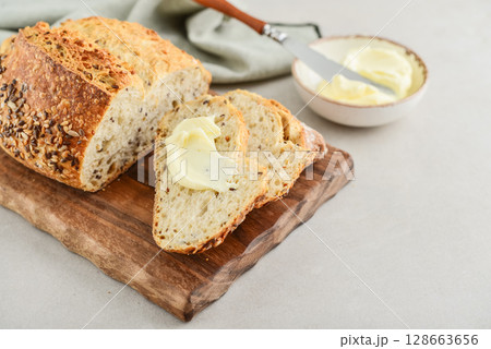 Tasty multigrain french bread with butter Tasty multigrain french bread with butter 128663656