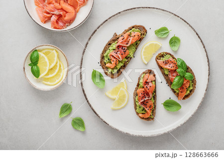 Open sandwiches with salted salmon and guacamole Open sandwiches with salted salmon and guacamole 128663666