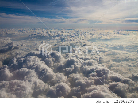 beautiful thick clouds in the sky from the height of the plane 128665278