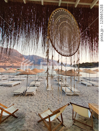 deck chairs and umbrellas on the sea beach in summer 128665288