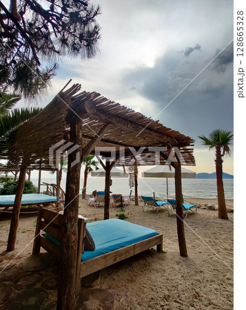 deck chairs and umbrellas on the sea beach in summer deck chairs and umbrellas on the sea beach in summer 128665328