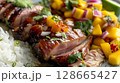 Close-up of Peking Duck with Mango Salsa, highlighting tender duck slices, vibrant salsa, and jasmine rice 128665427