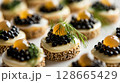 Close-up of Caviar with Quail Eggs, showcasing halved quail eggs topped with luxurious caviar and garnished with dill 128665429