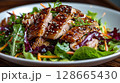 Peking Duck Salad: crispy skin on greens with hoisin vinaigrette, sesame seeds, and wonton strips 128665430