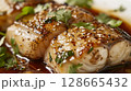 Ginger-Soy Turbot Meuniere: Tender turbot with ginger-soy marinade, served with ginger-soy sauce and fresh cilantro 128665432