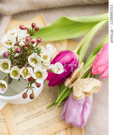 a beautiful arrangement of a bouquet of tulip flowers and a book a beautiful arrangement of a bouquet of tulip flowers and a book 128666353