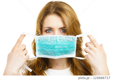 Female using protective face mask. 128666717