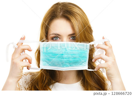 Female using protective face mask. 128666720