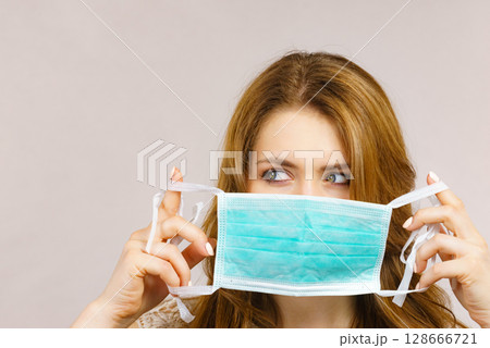 Female using protective face mask. 128666721