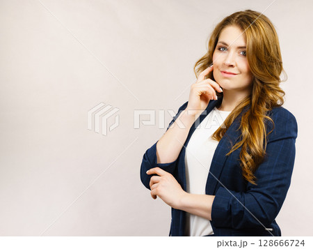 Business woman in suit looking at camera 128666724