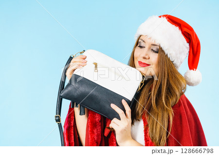 Christmas girl holding handbag present Christmas girl holding handbag present 128666798