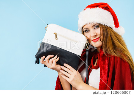 Christmas happy girl holding handbag present 128666807