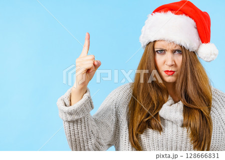 Woman threatens with finger, serious face expression 128666831