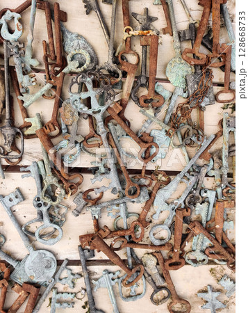 many old rusty vintage keys on the table 128668733