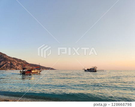 a beautiful ship is sailing in the blue sea 128668798