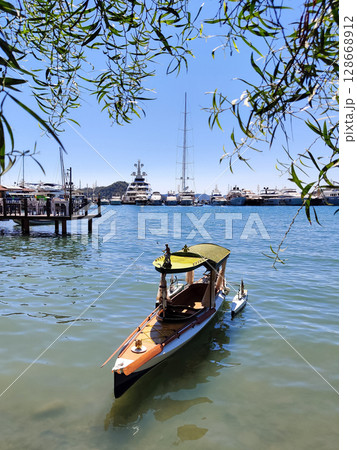 beautiful ships and boats are moored near the shore 128668912
