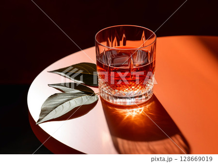 Negroni campari cocktail with ice and dry leaf on round table in bar lounge.Macro.AI Generative 128669019