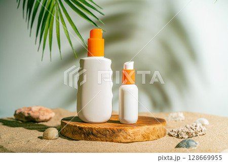 Two sun care bottles on wood stand 128669955