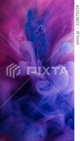 Flowing paint. Vapor art. Defocused blue purple neon color liquid smoke pigment swirling acrylic fog on abstract dark black background. Flowing paint. Vapor art. Defocused blue purple neon color liquid smoke pigment swirling acrylic fog on abstract dark black background. 128670256