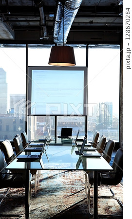 A glass table with a projector screen and a laptop on it 128670284
