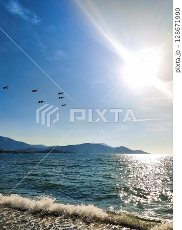 a beautiful air show of fighter jets in the sky over the sea a beautiful air show of fighter jets in the sky over the sea 128671990