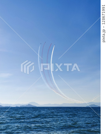 a beautiful air show of fighter jets in the sky over the sea a beautiful air show of fighter jets in the sky over the sea 128671991