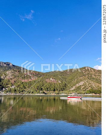 a beautiful ship is sailing in the blue sea 128672075