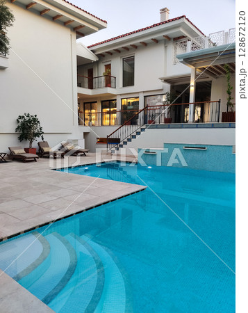 a beautiful large swimming pool near the house a beautiful large swimming pool near the house 128672120