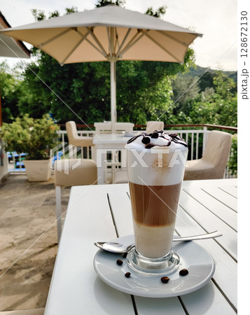 close-up of a three-layer coffee latte in a transparent glass close-up of a three-layer coffee latte in a transparent glass 128672130