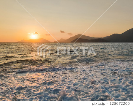 beautiful dramatic landscape of sunset on the sea beach 128672200