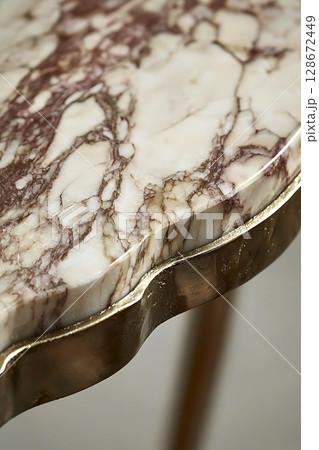 A marble table with gold trim 128672449