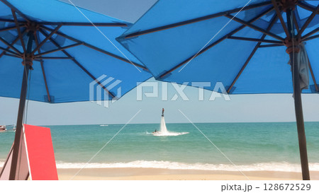 a guy flies on a flyboard at sea 128672529