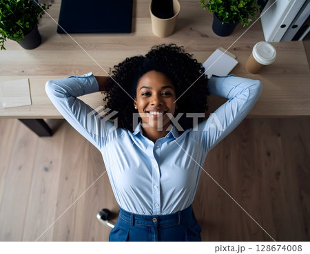 Businesswoman Relaxing on Desk in Modern Office 128674008