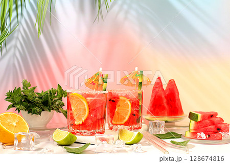 Mojito with lemon, mint, watermelon, ice with tequila, vodka or soda water on elegant background, minimalist concept for bar, soft drink for weight loss, advertising banner for cafe Mojito with lemon, mint, watermelon, ice with tequila, vodka or soda water on elegant background, minimalist concept for bar, soft drink for weight loss, advertising banner for cafe 128674816
