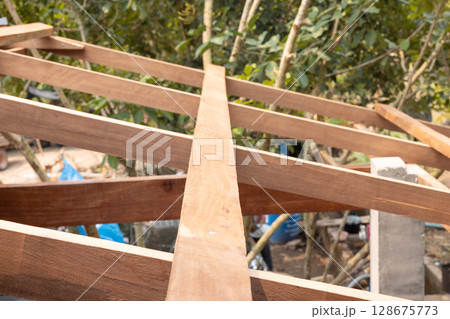 Roof under construction with metal sheet and wood structure. 128675773