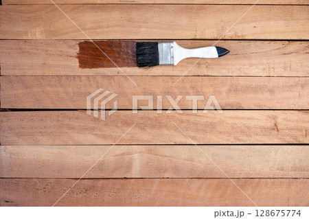 Paint brush and wood material in construction work. 128675774