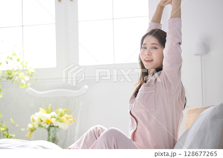 ベッドで寛ぐ若い女性 128677265