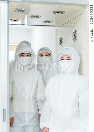 エアーシャワー・クリーンルームのある工場で働く人 128679331