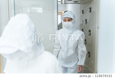 エアーシャワー・クリーンルームのある工場で働く人 128679332