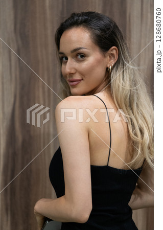 Elegant Blonde in a Black Dress Exuding Confidence and Timeless Beauty. Elegant Blonde in a Black Dress Exuding Confidence and Timeless Beauty. 128680760