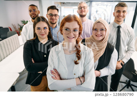 A group of business professionals standing together, taking a well-deserved break from their busy workday, showcasing camaraderie, teamwork, and a moment of relaxation in their dynamic workplace A group of business professionals standing together, taking a well-deserved break from their busy workday, showcasing camaraderie, teamwork, and a moment of relaxation in their dynamic workplace 128680790