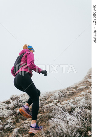 Trail Runner in Misty Mountain Landscape Trail Runner in Misty Mountain Landscape 128680940