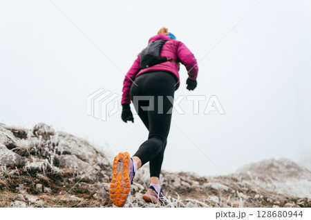 Trail Runner in Misty Mountain Landscape Trail Runner in Misty Mountain Landscape 128680944
