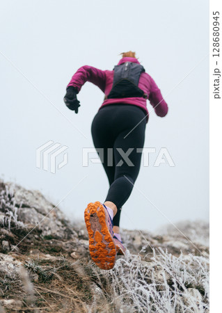 Trail Runner in Misty Mountain Landscape Trail Runner in Misty Mountain Landscape 128680945
