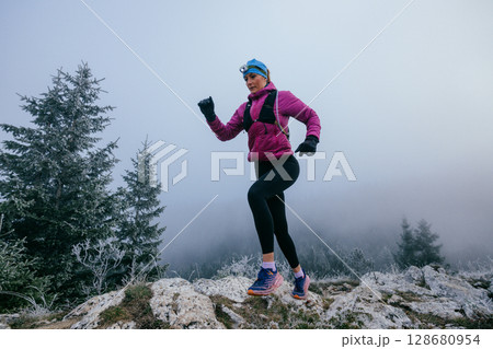 Trail Runner in Misty Mountain Landscape 128680954