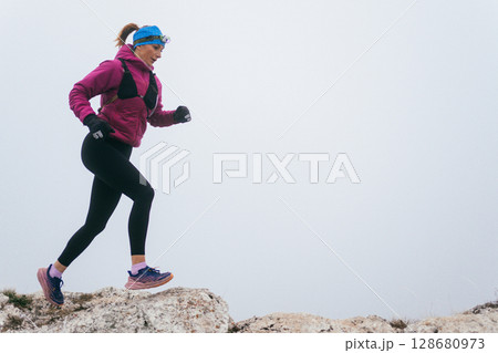 Trail Runner in Misty Mountain Landscape Trail Runner in Misty Mountain Landscape 128680973