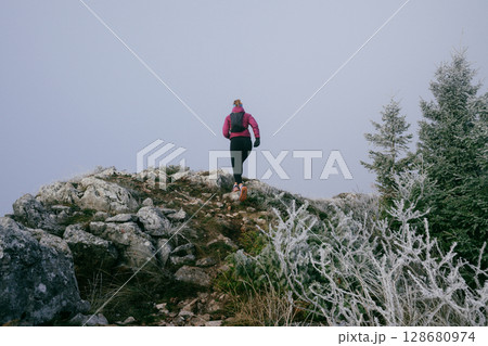 Trail Runner in Misty Mountain Landscape 128680974